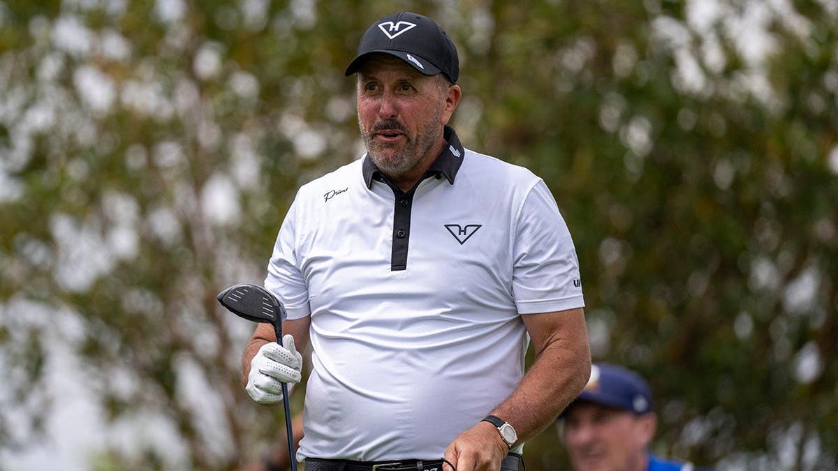 Phil Mickelson playing a golf shot from the fifth tee
