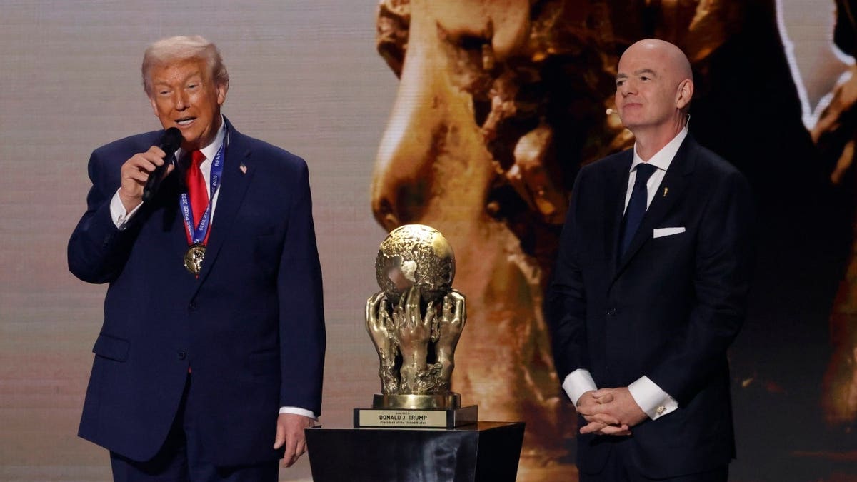 United States President Donald Trump speaks after receiving the FIFA Peace Prize from FIFA President Gianni Infantino during the World Cup 2026 Final Draw.