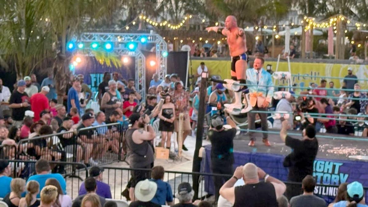 Fans watch as wrestlers hit the ring