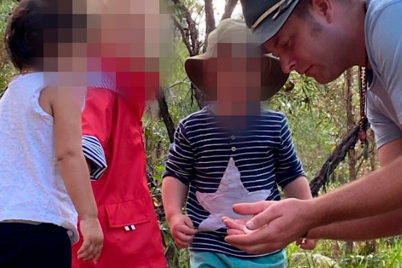 Photographs posted online show Tait speaking with children in bushland settings.