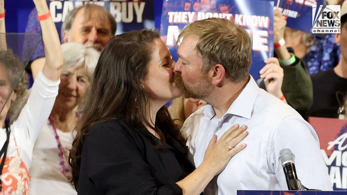 Graham Platner and his wife, Amy Gertner kiss at his watch party