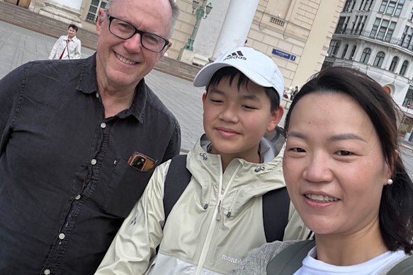 Charlie flanked by his teacher, Glenn Riddle, and mother, Ashleigh Wu, outside the Bolshoi Theatre in Moscow.