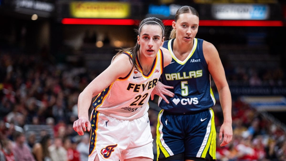 Dallas Wings guard Paige Bueckers defends Indiana Fever guard Caitlin Clark during an inbounds play in a WNBA game at Gainbridge Fieldhouse in Indianapolis.