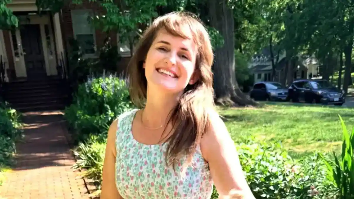 Lyndsey Fifield smiles in front of a house