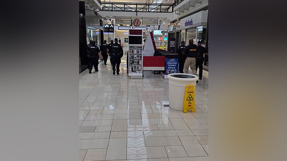 Law enforcement officers clear businesses inside Deerbrook Mall