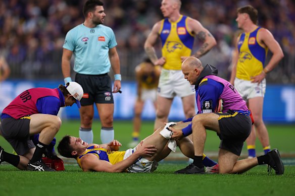 Oliver Francou receives on-field treatment on his knee.