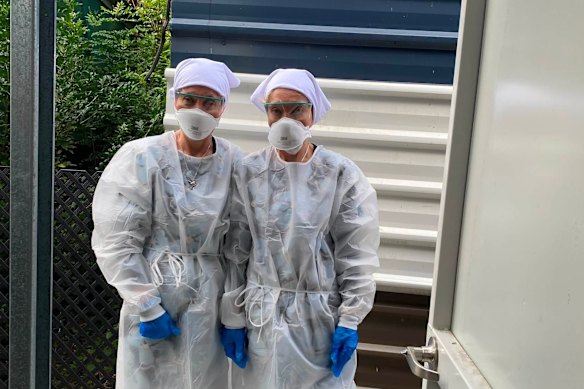 Twinnies Pelican and Seabird Rescue owners Bridgette and Paula Powers wearing PPE to handle a sick bird.