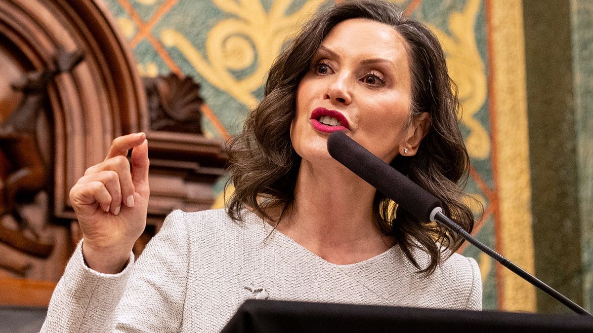 Gretchen Whitmer speaks at a podium inside the Michigan state Capitol.