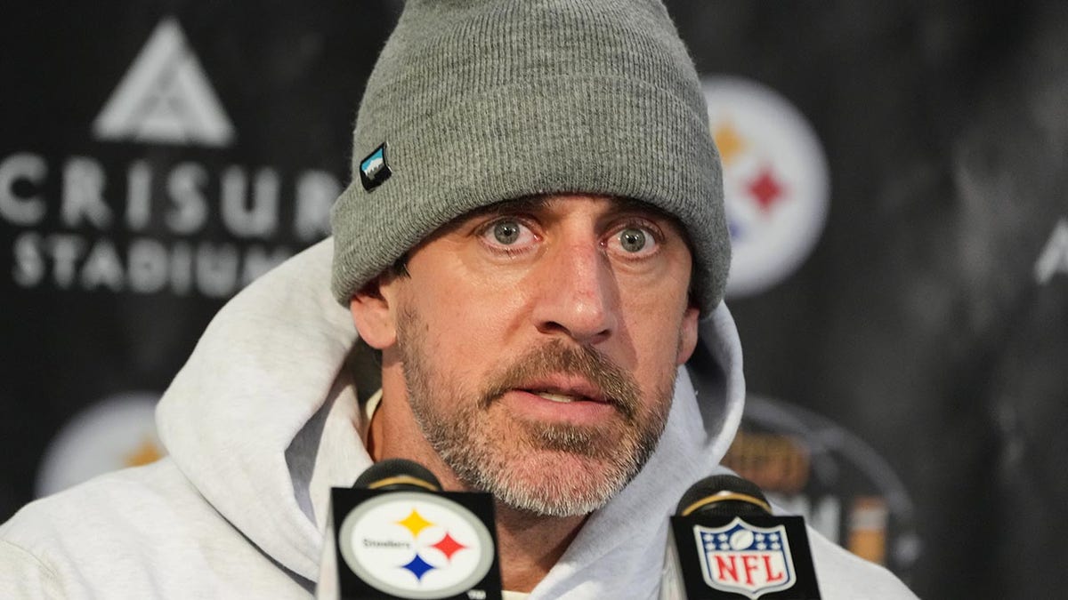 Aaron Rodgers talks to the media