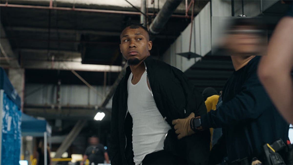 Caleed Mouton, a suspect, arrives to the Federal Building after his arrest.