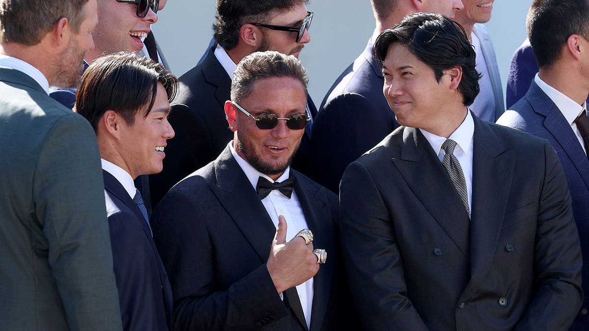 Shohei Ohtani, Miguel Rojas and Yoshinobu Yamamoto react at the White House.