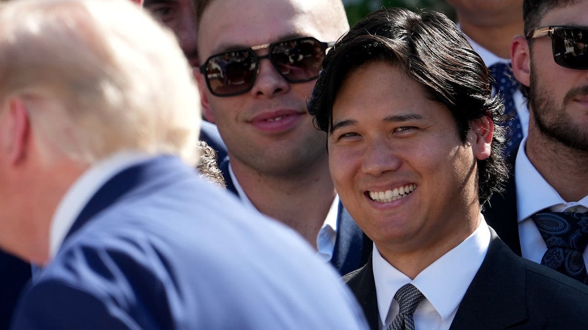 Shohei Ohtani listens as President Donald Trump speaks during a White House event.