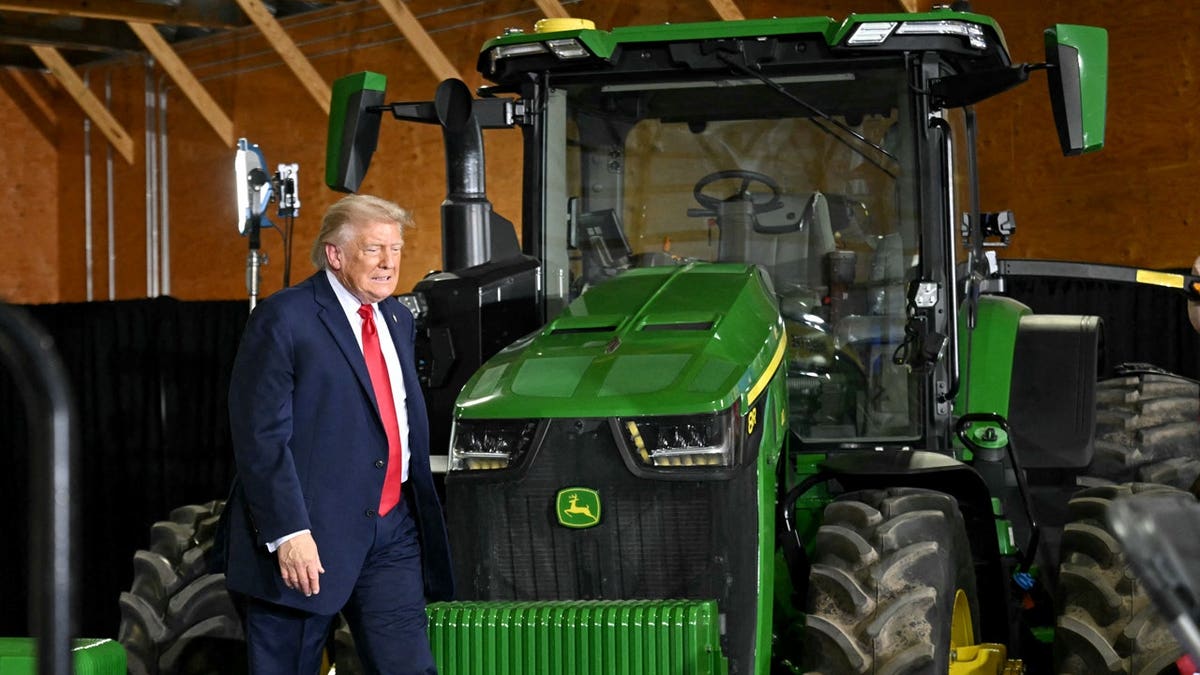Trump walking by tractor at farmer event