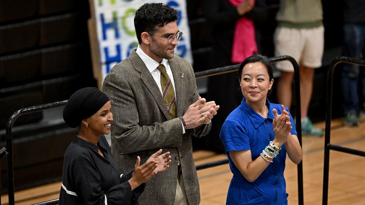 omar, piker, hong at rally clapping