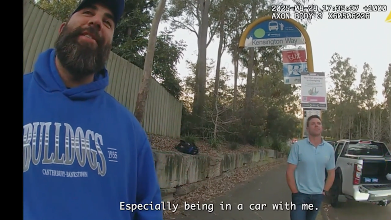Construction figures from BMD captured alongside alleged bikie at traffic stop, reading newspaper Construction figures from BMD captured alongside alleged bikie at traffic stop, reading newspaper