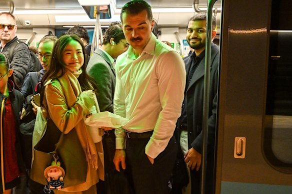 Crows Nest resident Lucy Wang, left, on a packed city-bound metro train during the morning peak.