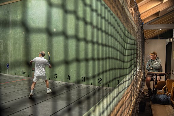 Ron Daniel (right) watches a game of real tennis being played at the Cheltenham Recreation Club. 