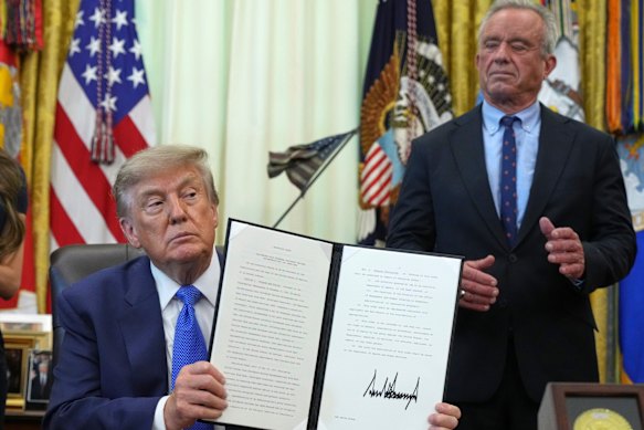 President Donald Trump holds an  executive order about vaccines alongside Health Secretary Robert F. Kennedy jun.