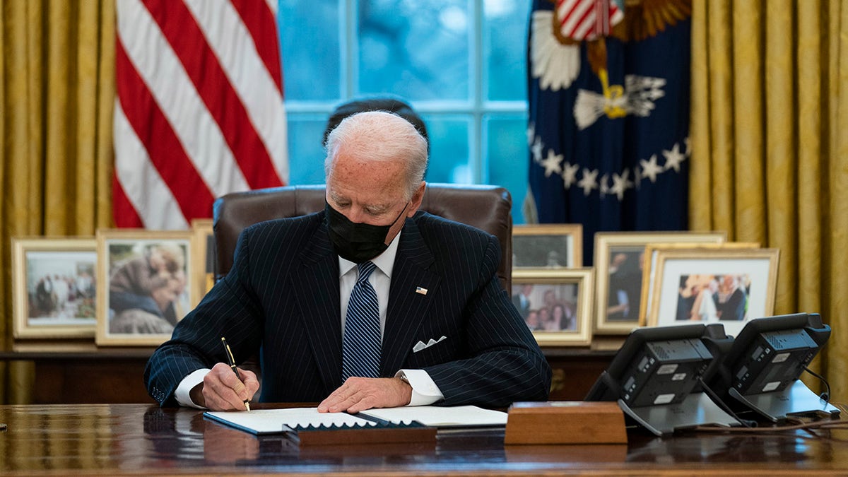 Joe Biden signs executive order Oval Office