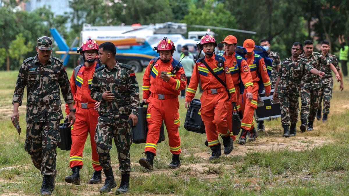 Chinese rescue workers arrive at Maithali Barrack, an army training centre that serves as a primary base for airlifting survivors, following deadly flash floods and a mudslide in Trishuli, Nuwakot district, Nepal, August 29, 2026.