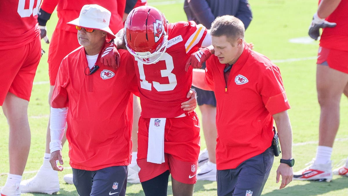 Cyrus Allen is helped off the field during training camp