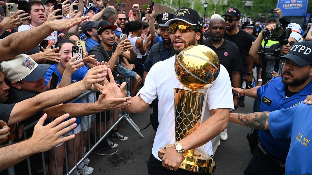 Jalen Brunson stands at the New York Knicks ticker-tape parade in New York City.
