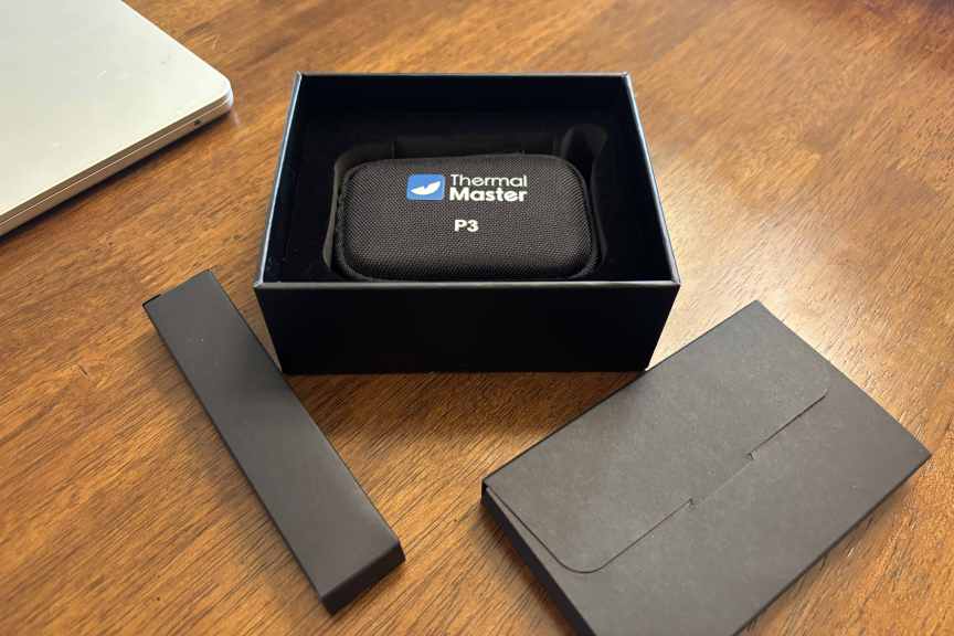 The Thermal Master add-on in its box on a table.