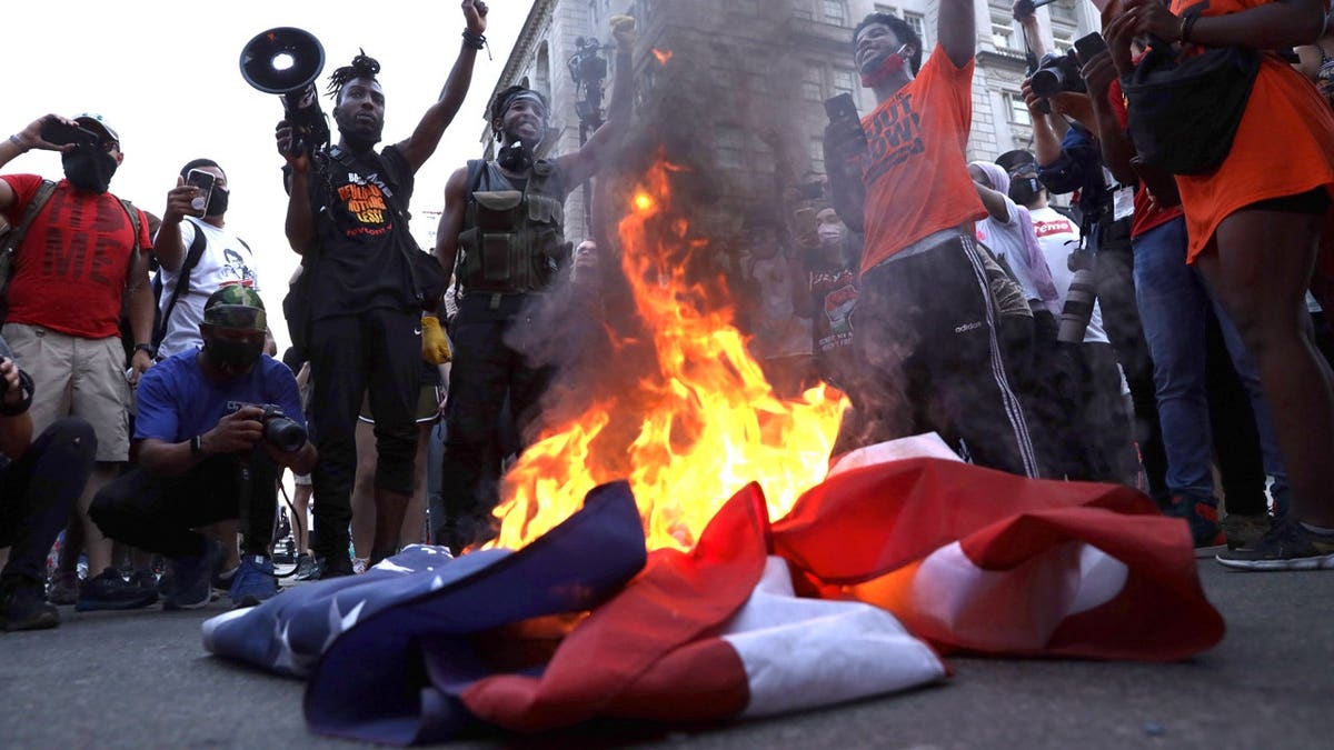 protestors burning american flag