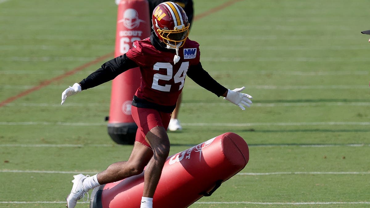 Ahkello Witherspoon participates in a drill during Washington Commanders training camp.
