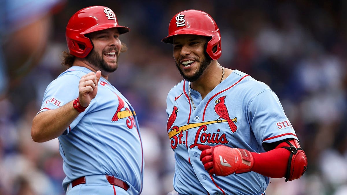 Joshua Báez of the St. Louis Cardinals celebrates with Alec Burleson after hitting a home run at Wrigley Field.