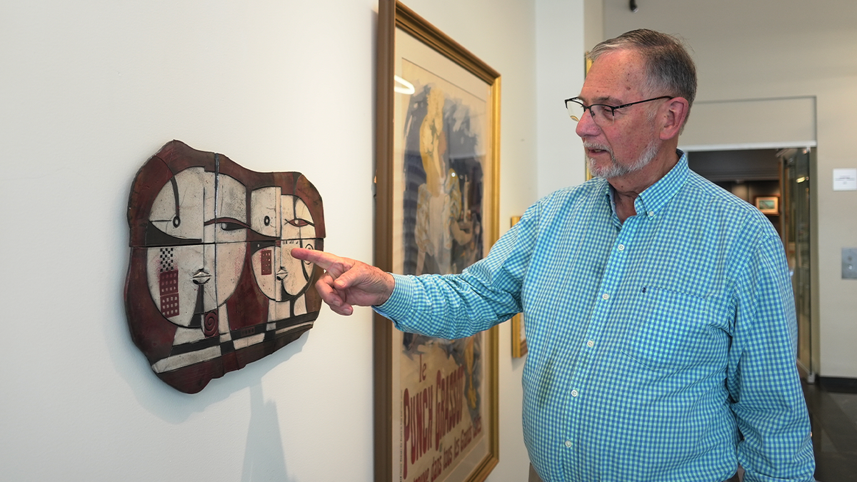 Bill DeLind stands inside his Milwaukee gallery after police recovered a signed Picasso print stolen from the business in 2018