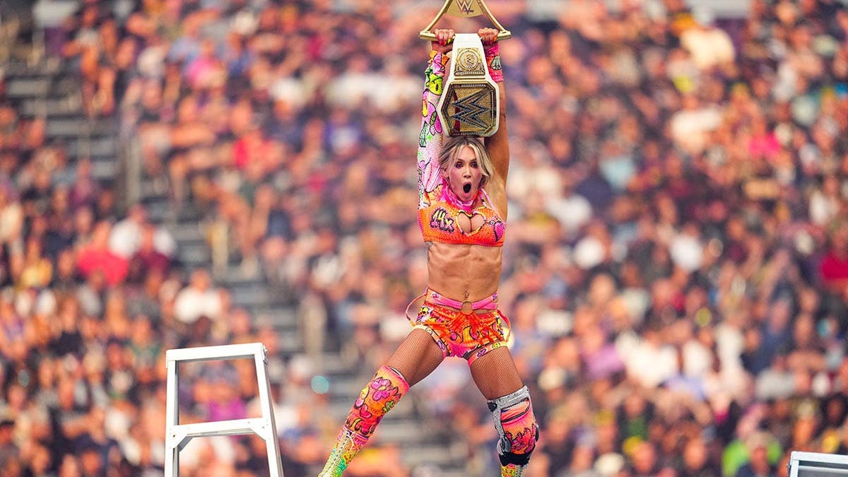 Charlotte Flair holds the WWE Women's Championship during SummerSlam at U.S. Bank Stadium.