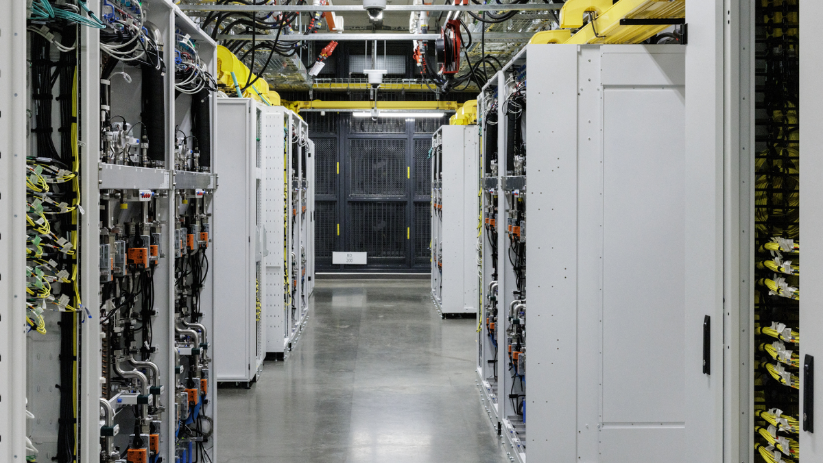 Racks of graphics processing units with a closed-loop liquid cooling system are seen inside an operational Microsoft data center.