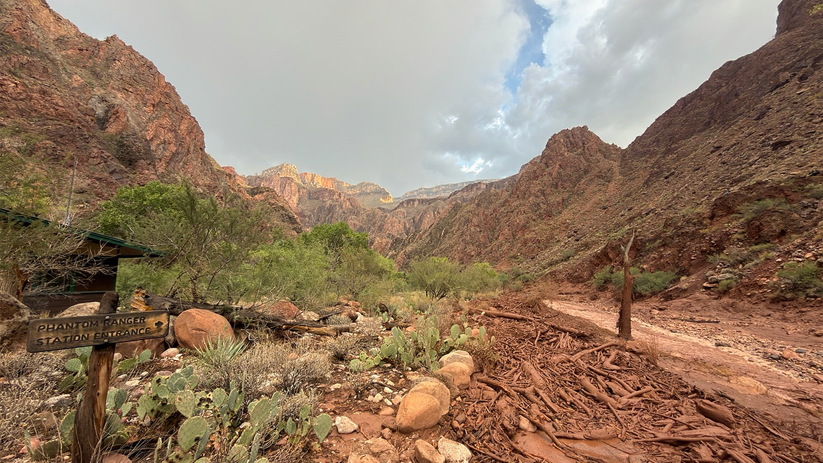 Flood debris and muddy water surround the Phantom Ranger Station entrance in the Grand Canyon after severe flash flooding