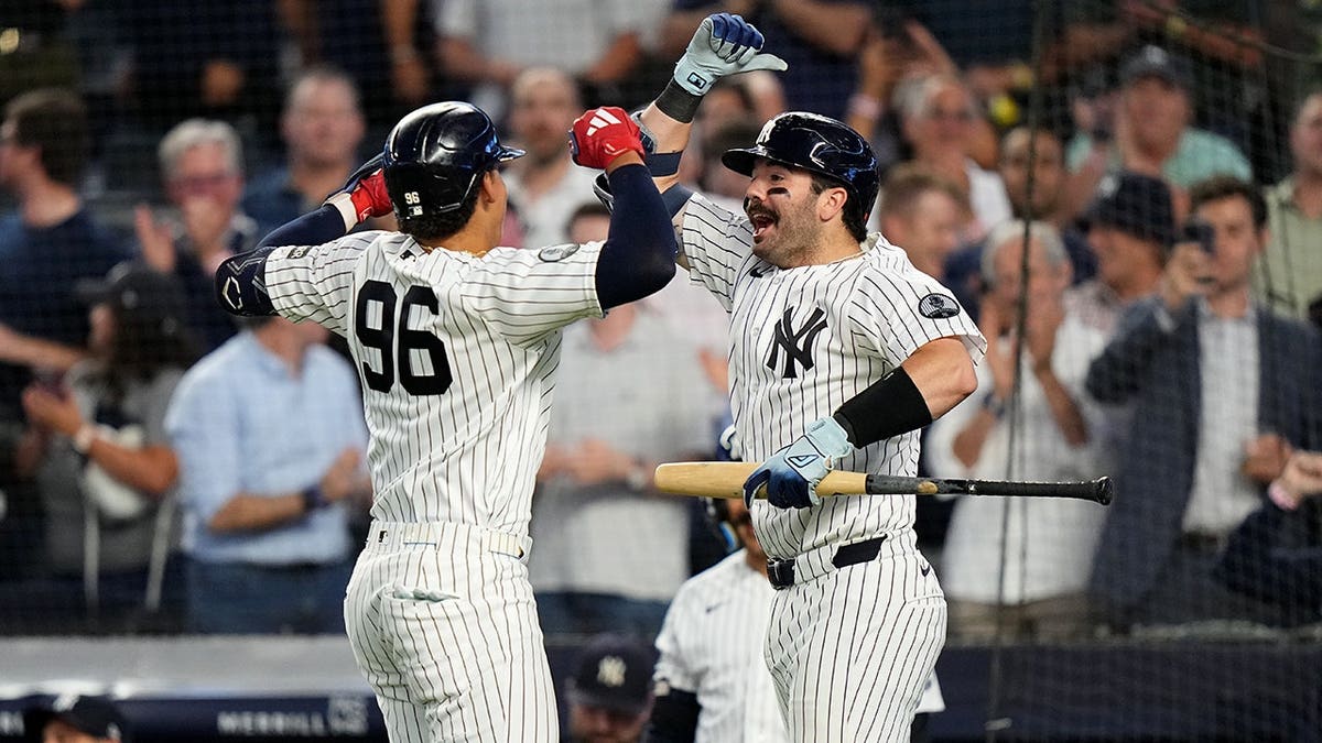 Austin Wells celebrates with George Lombard Jr. after his home run.
