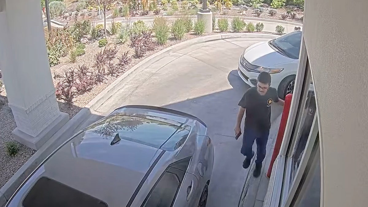 This image taken from video provided by the Twin Falls Police Department shows Chad Williams holding a gun and approaching a car in an In-N-Out drive-thru Saturday, Aug. 1, 2026, in Twin Falls, Idaho. 