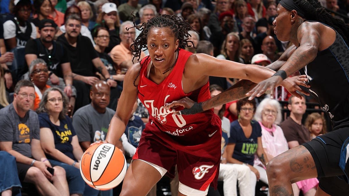 Kelsey Mitchell #0 drives to the basket during a game at Target Center.
