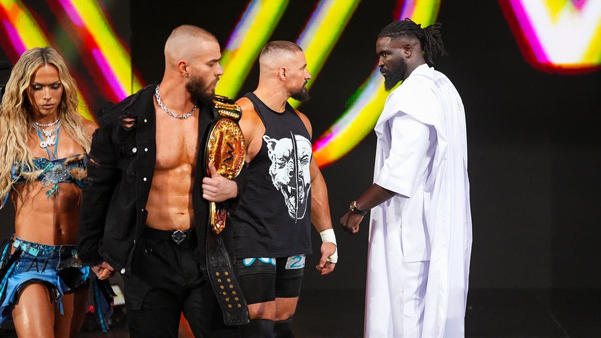 Maxxine Dupri, Austin Theory and Bron Breakker enter the ring while Oba Femi looks on.