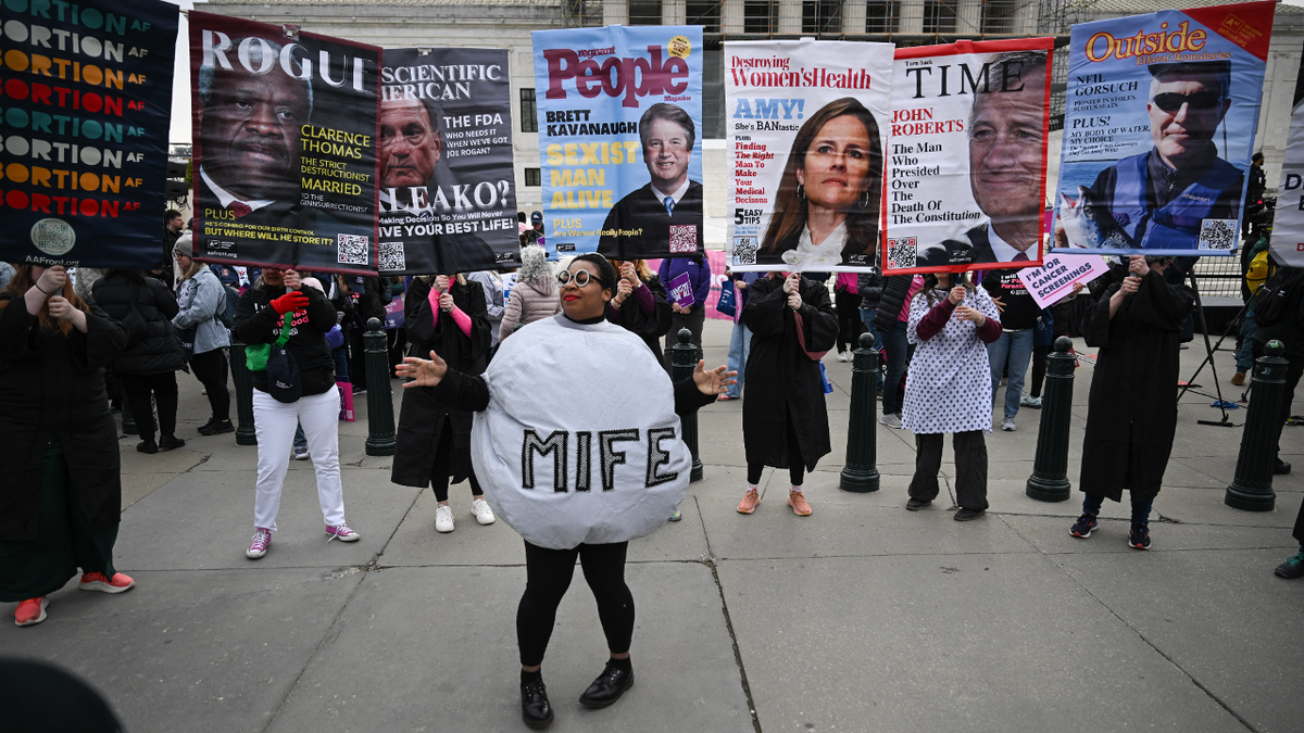 A woman dressed as a mifepristone pill
