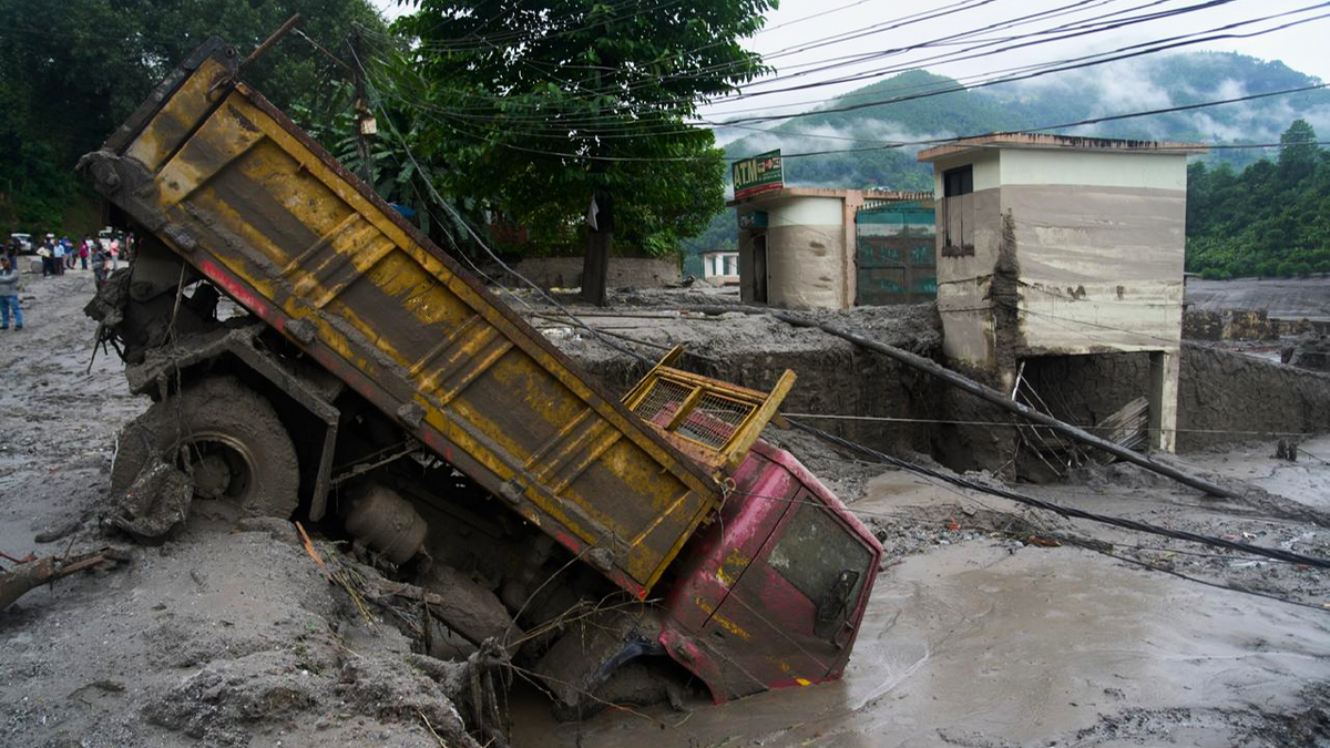 A vehicle is seen in the aftermath of a flash floods in Devighat