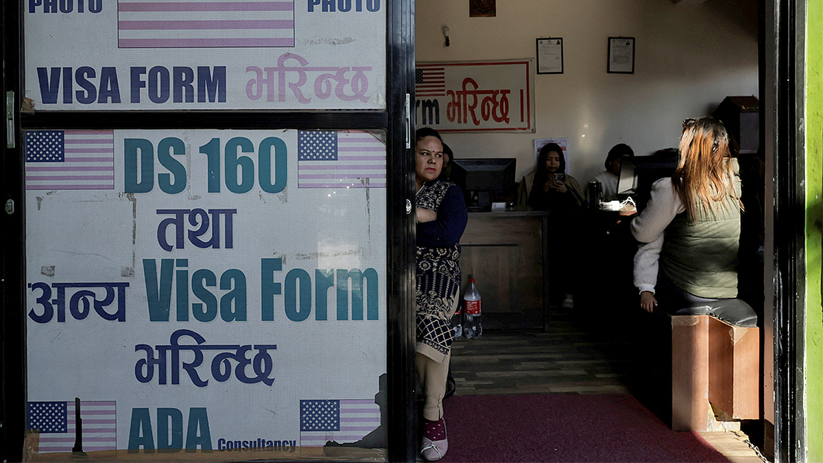 A woman waits to fill out a U.S. visa application form