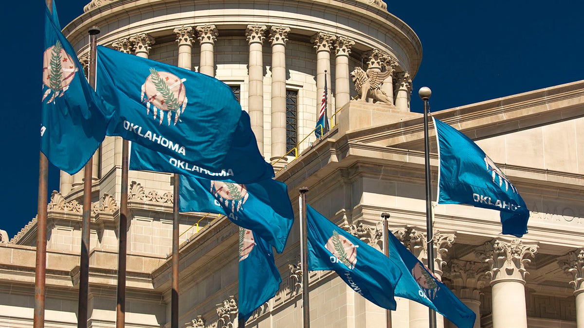 Oklahoma flags fly outside the state capitol