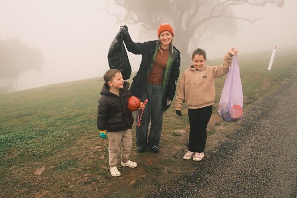 Alex Whitford and two young residents during a cleanup last week. 