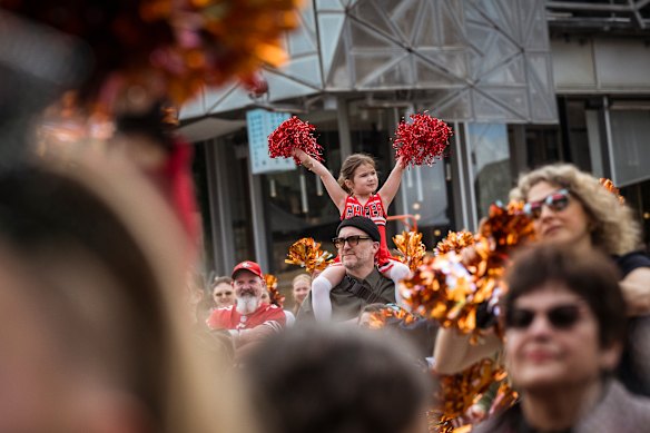 Penny Tropman, 5, sat atop dad Aaron’s shoulders to participate in the record-breaking cheer dance.