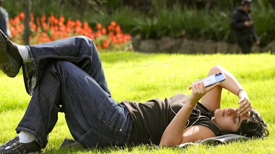 Scarlett Keast basking in the sun on the first day of spring in Fitzroy Gardens.