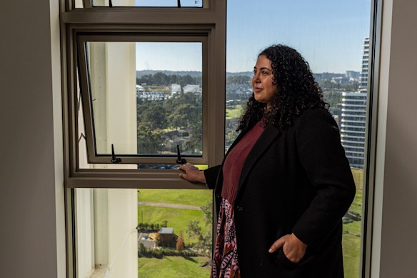 Estelle Grech of the Committee for  Sydney next to a standard sash window in the Boronia development in Norwest Quarter. 