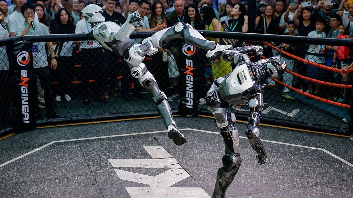 Robots fight during an MMA-style performance at Engine AI booth at the 2026 World Robot Conference, in Beijing, China,