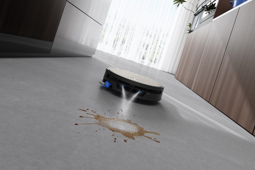 FocusJet robovac in the process of cleaning a spill on the hard flooring.