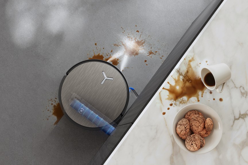 FocusJet robovac in the process of cleaning a coffee spill on the hard flooring.