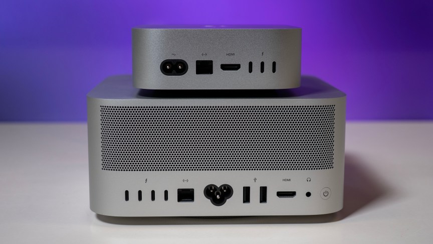 a mac mini on top of a mac studio from behind, showing all of the rear ports and connection options.
